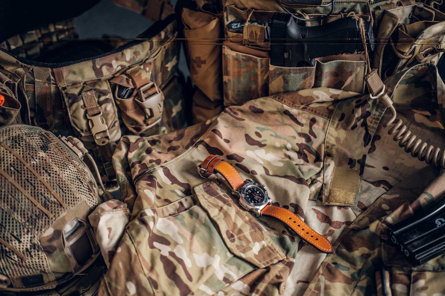 still life with nice watch military uniform with typical camo pattern