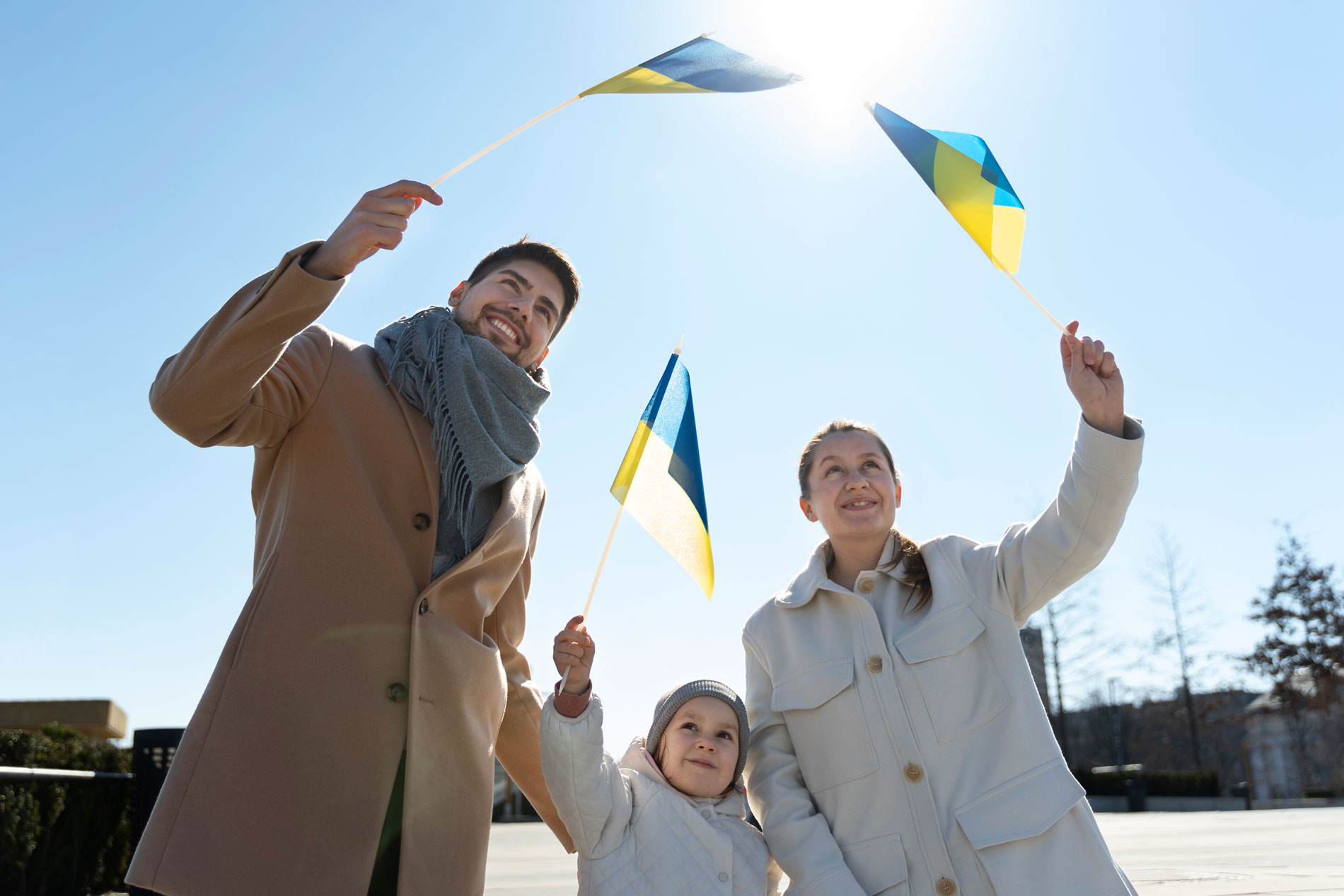 medium shot happy family with ukrainian flags