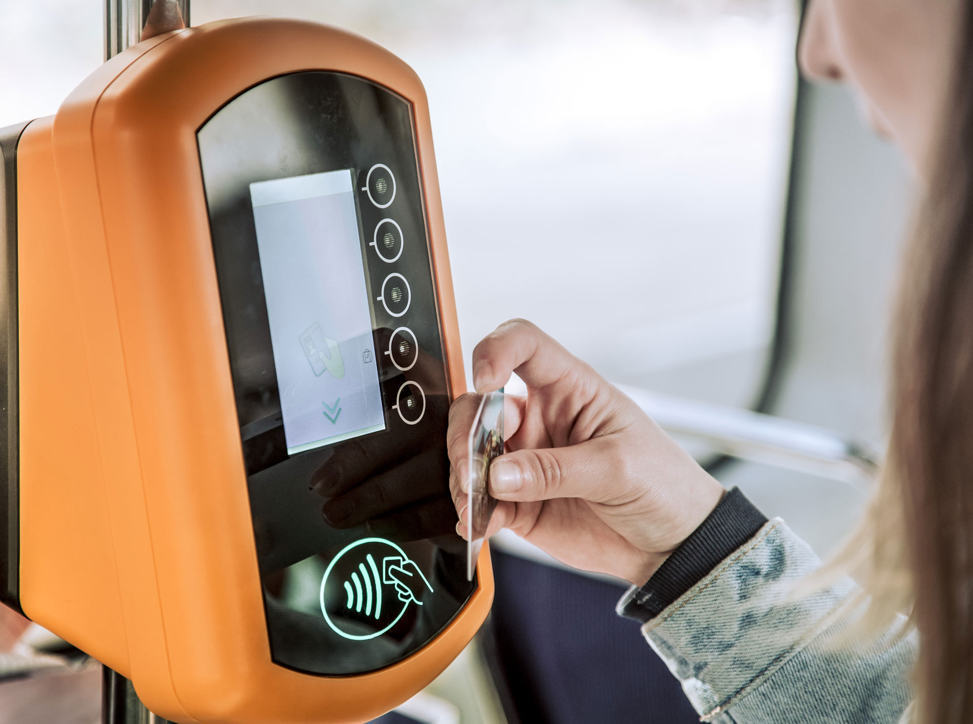young woman contactless pays public transport