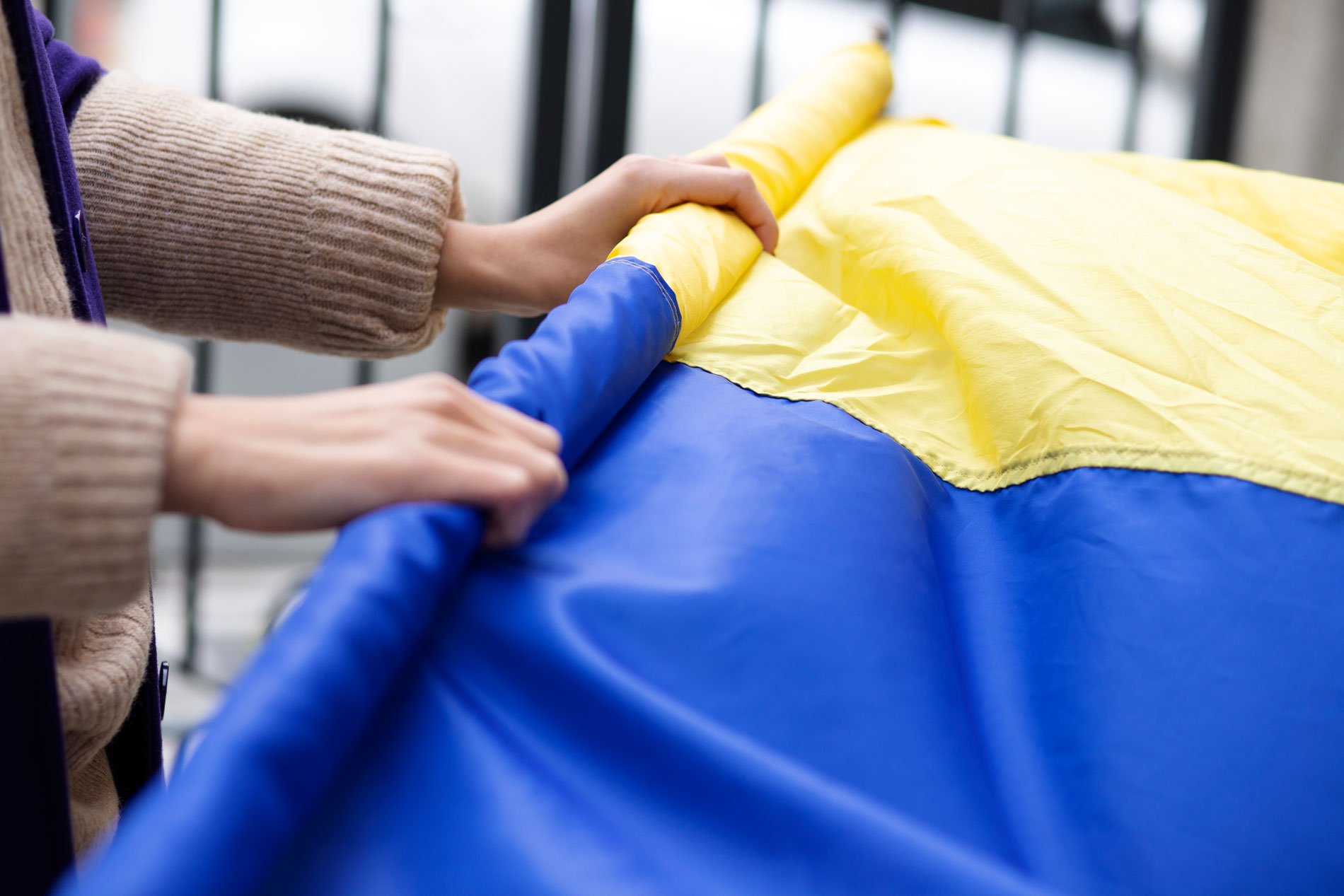 person wrapping ukrainian flag