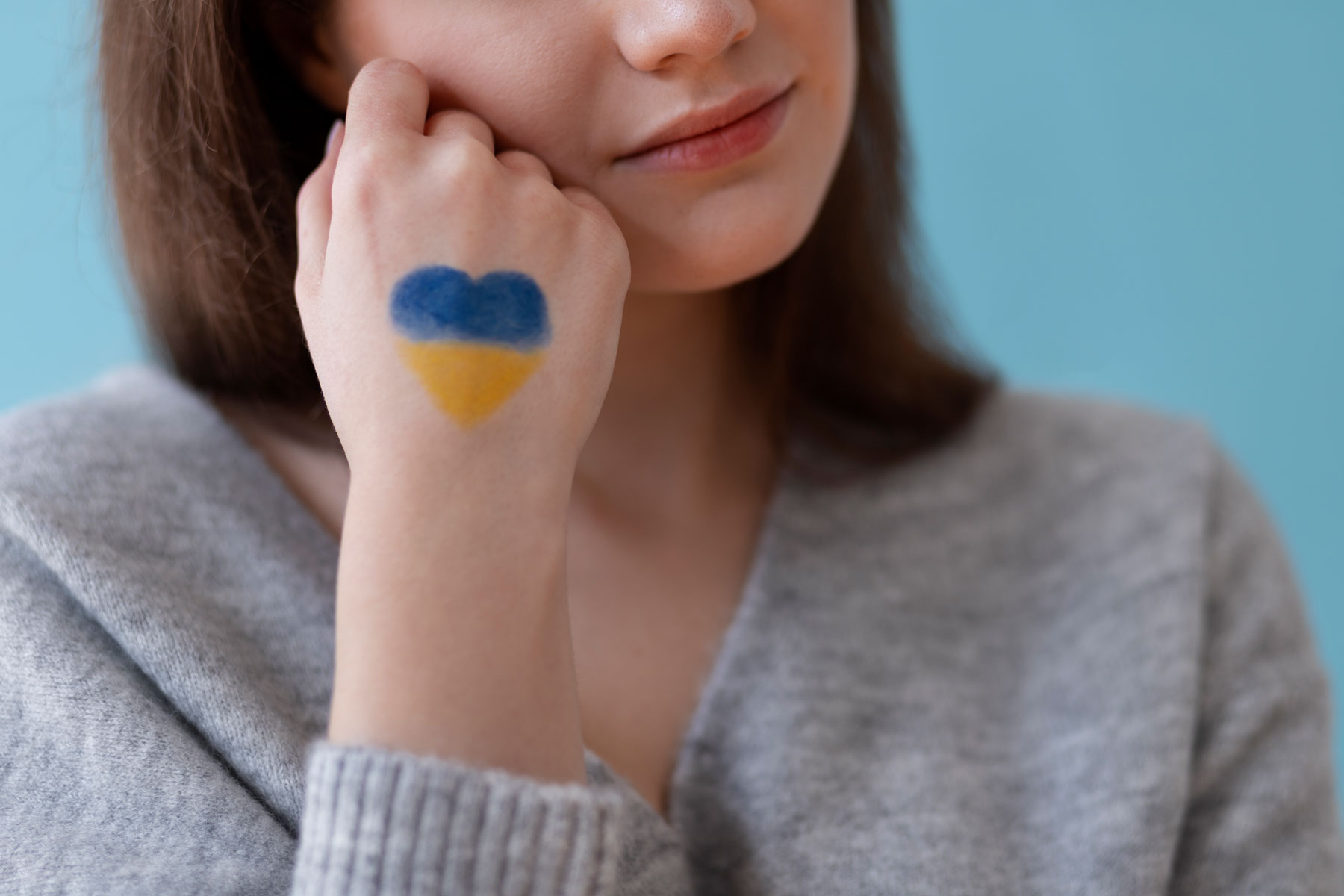 woman with ukrainian flag drawing hand