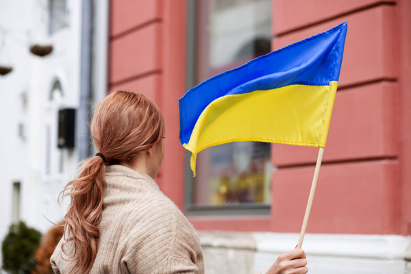 woman holding ukrainian flag thumb